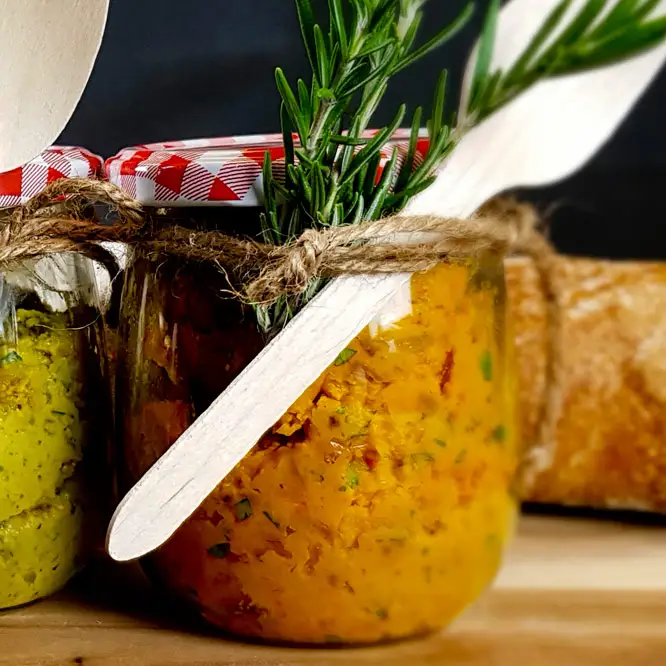 Kürbis-Senf Aufstrich Leuchtend gelber Aufstrich mit Kürbis und würzigem Senf. Angerichtet in einem schönen Einmachglas mit Kräutern und Holzlöffel dekoriert